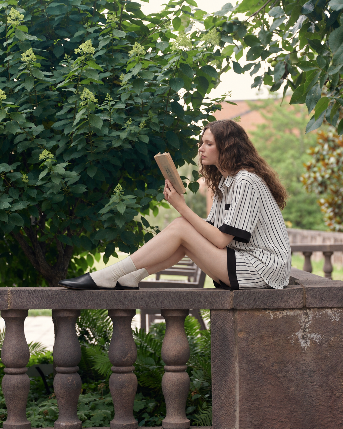 Contrast-Band Striped Viscose-Blend Pajama Shorts Set – black seated reading by a stone balustrade - Roomden