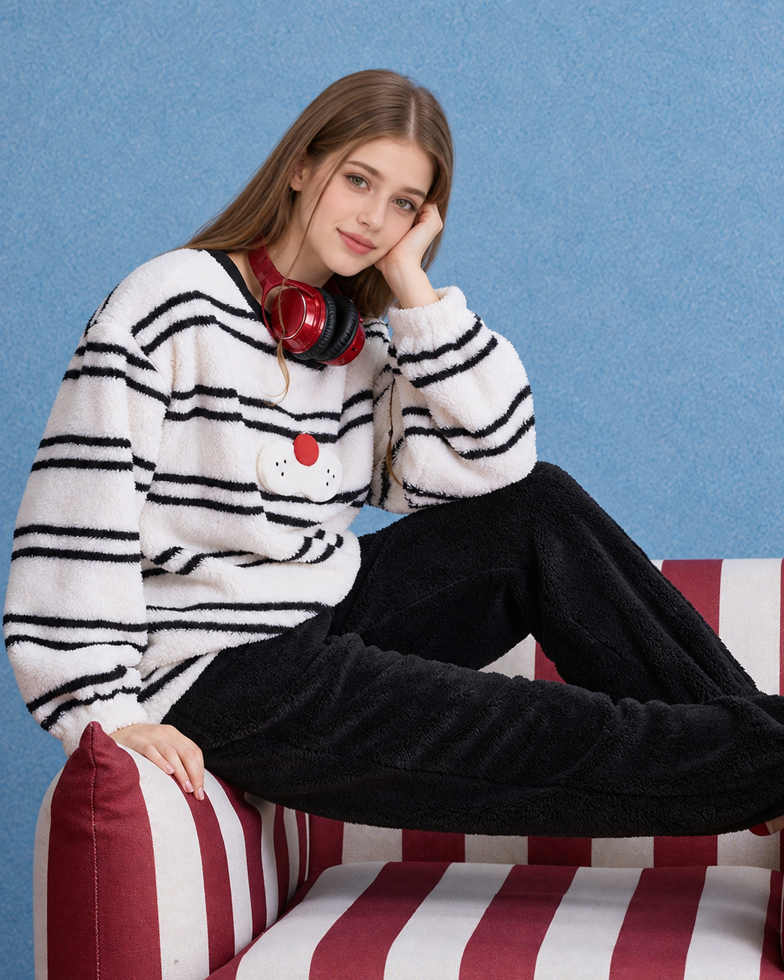 Whiskerbeat striped cat plush pajama set - Side seated view showing black plush trousers - Roomden