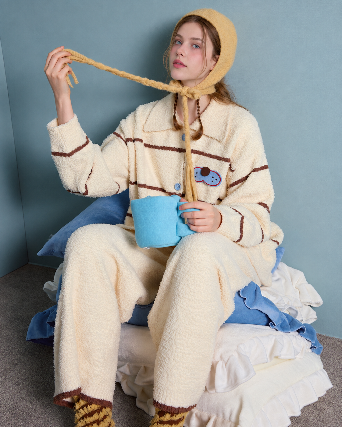 Striped Cat Fleece Pajama Set – front seated view with a blue cup - Roomden