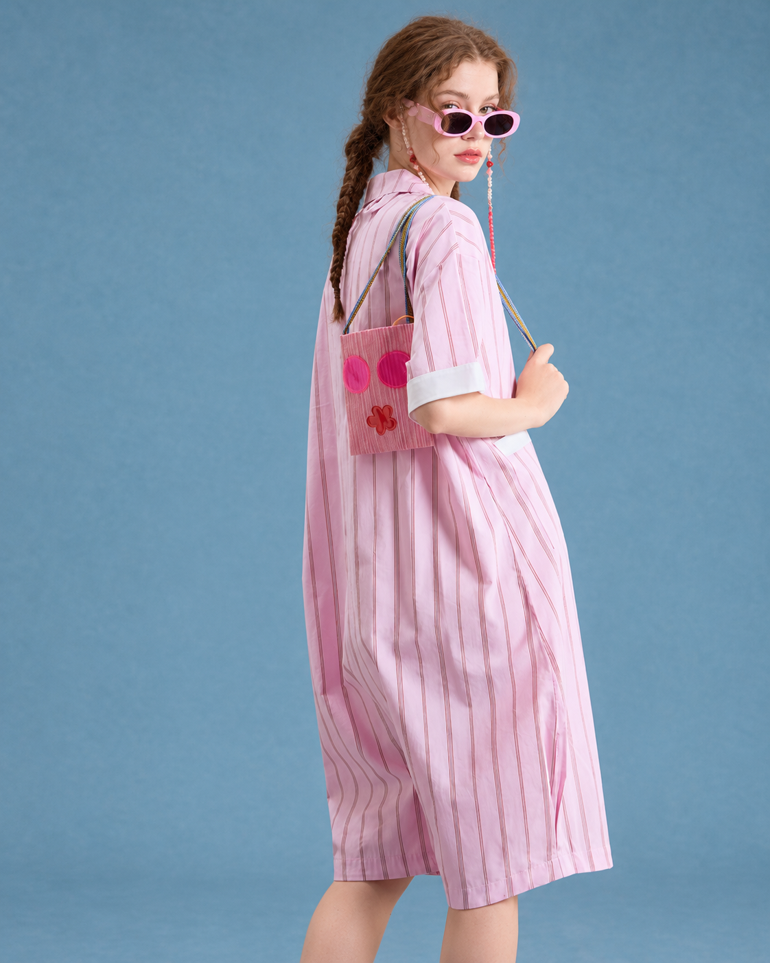 Striped cotton one-piece pajamas – pink rear three-quarter view - Roomden