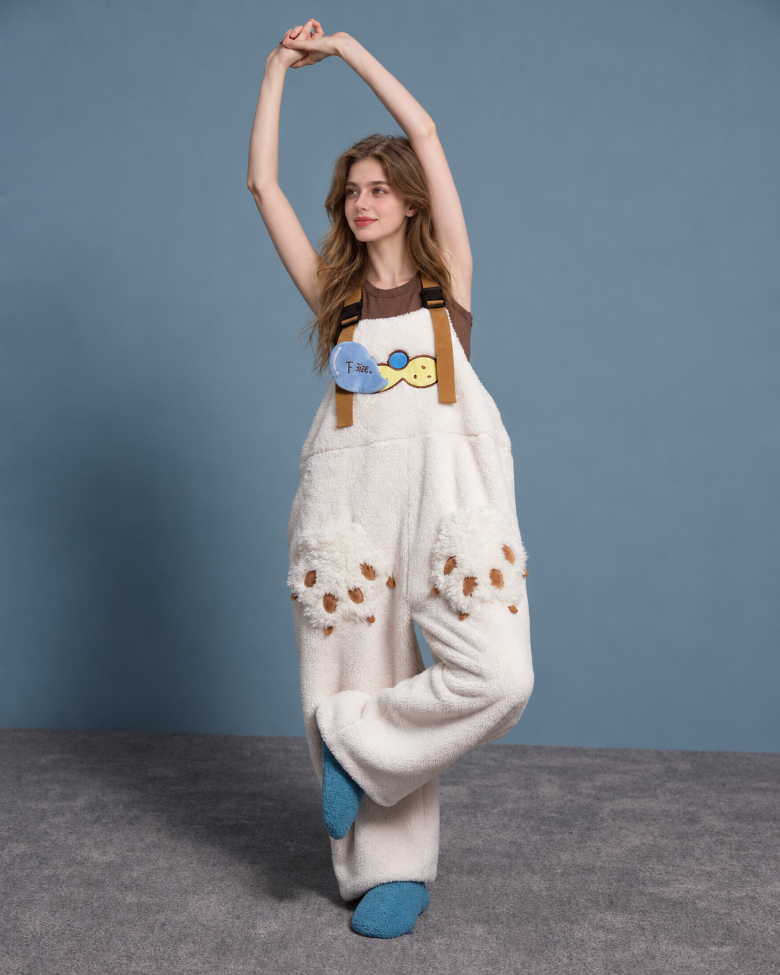 Cat-paw plush one-piece pajamas – cream front raised-arm view - Roomden