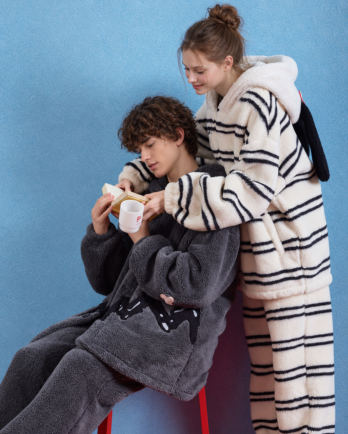 Hooded plush pajama set – charcoal gray seated reading view with companion - Roomden