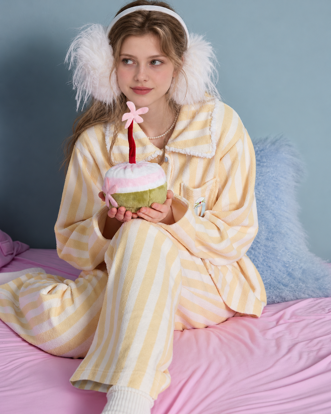 Striped fleece pajama set – smiling seated view holding a plush cake - Roomden