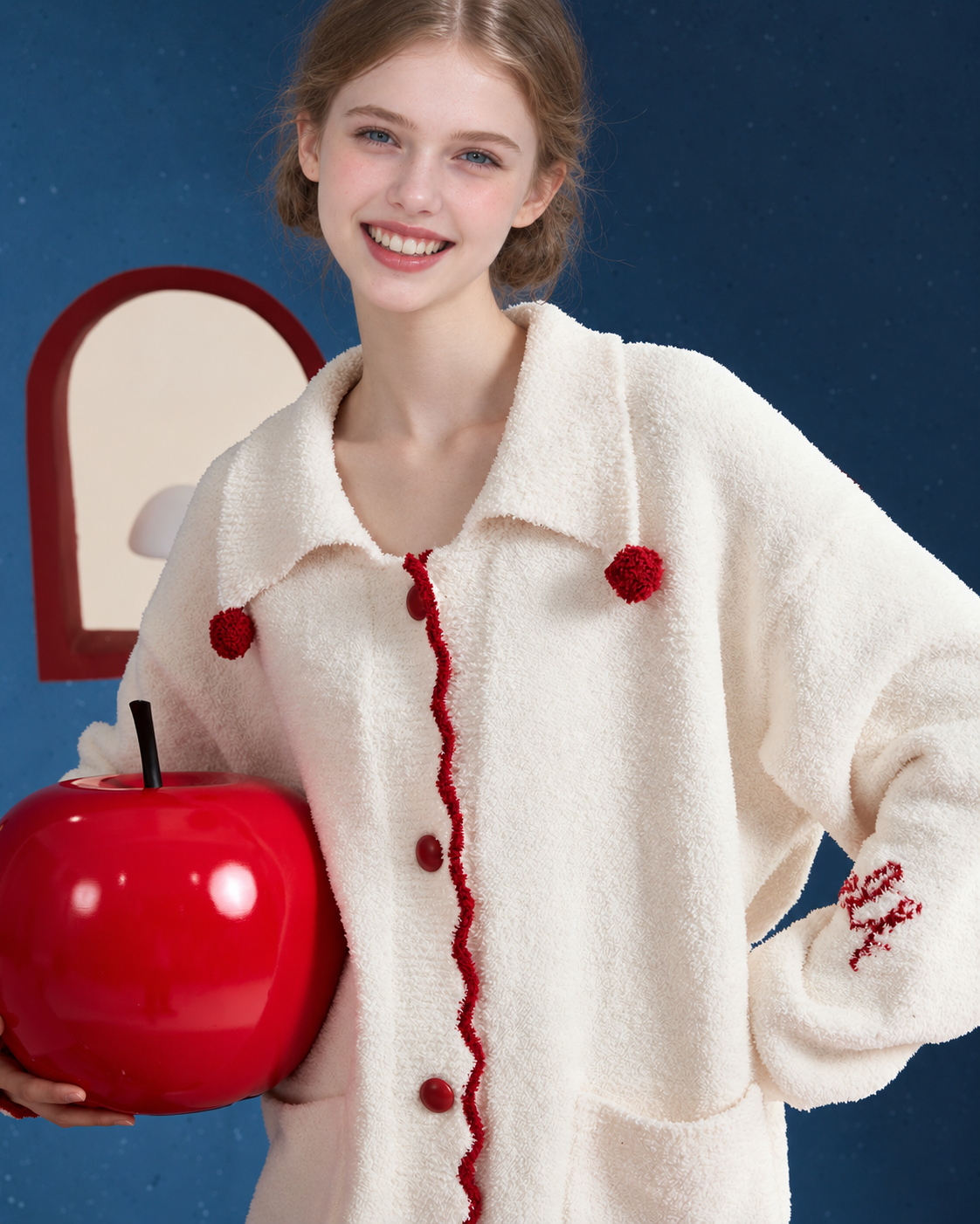 Pom-Pom Fleece Pajama Set – ivory upper-body view with apple prop and front patch pockets - Roomden