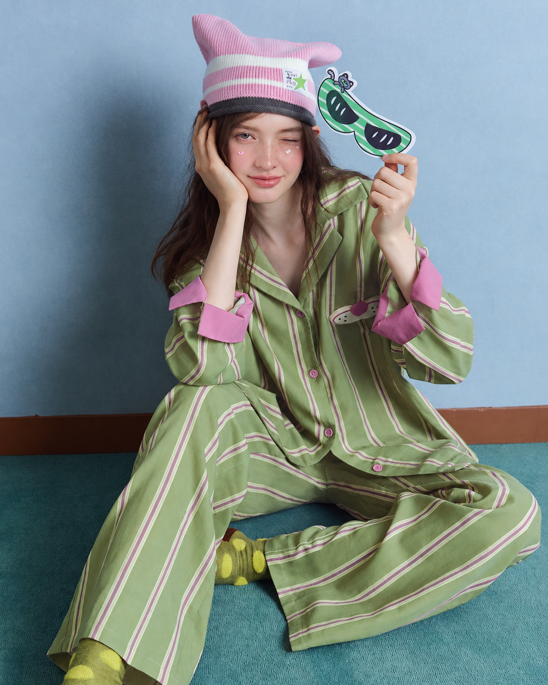 Cat Detail Cotton Gauze Pajama Set – seated on the floor wearing the striped set - Roomden