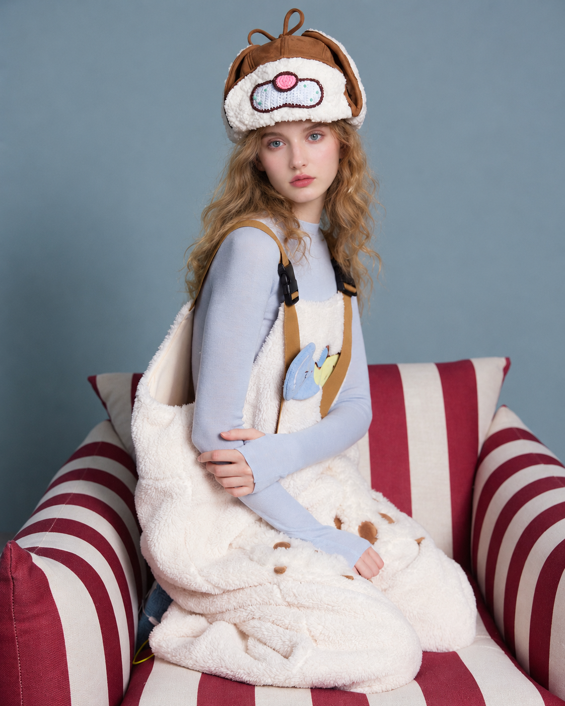 Cat-paw plush one-piece pajamas – cream side seated view - Roomden