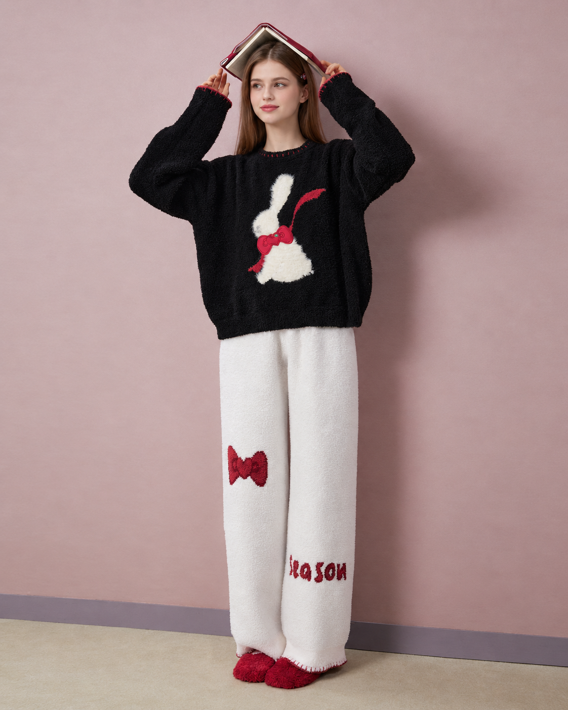 Rabbit & Bow Fleece Pajama Set – front view with a book held above the head - Roomden