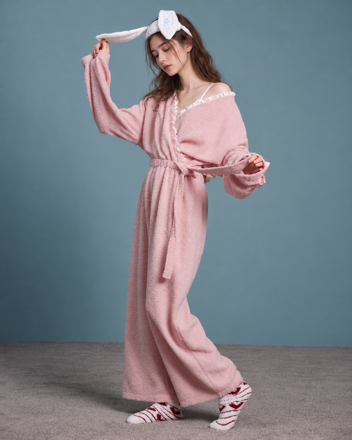 Blush Pink Plush Onesie – standing side-angle sleeve view - Roomden