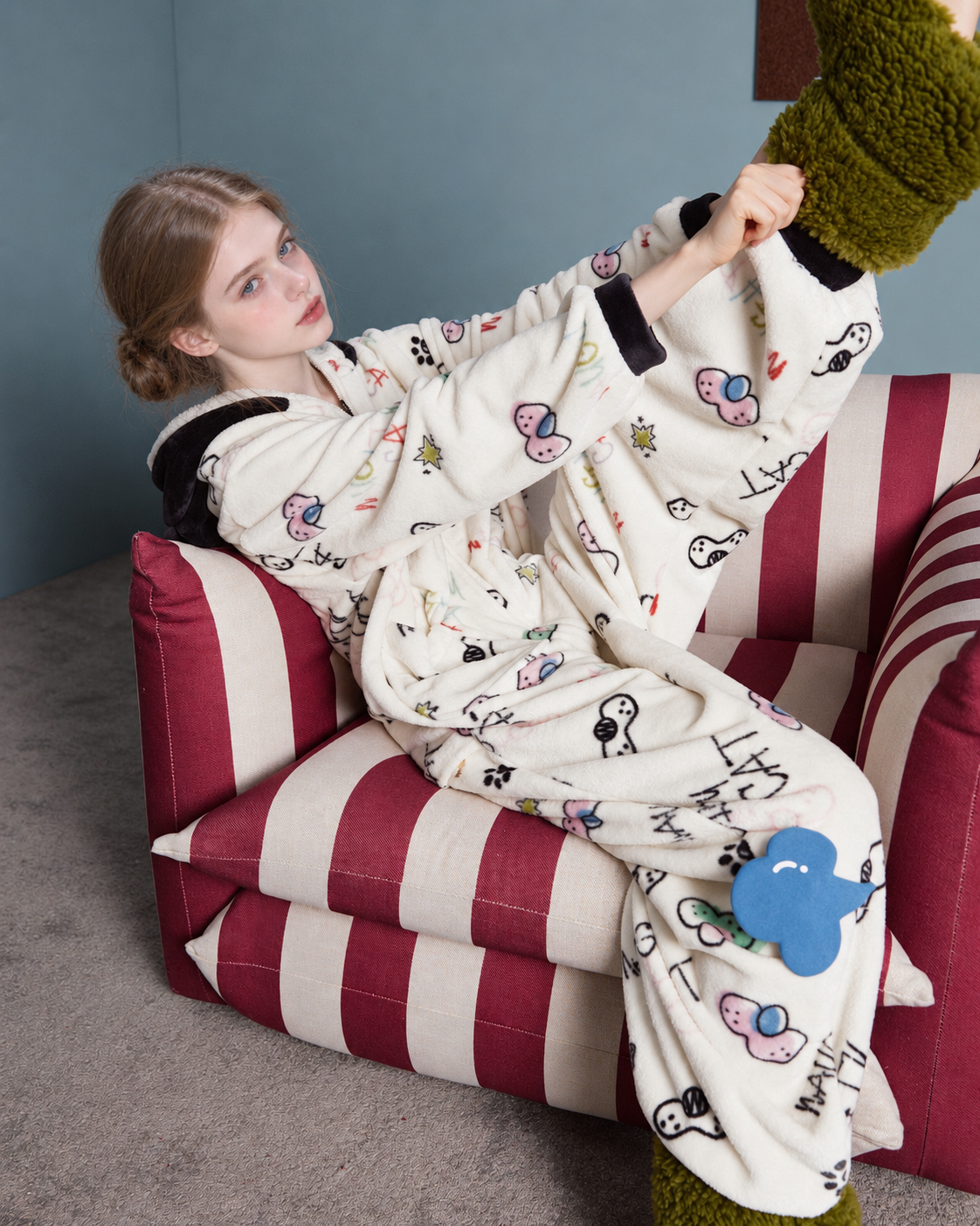 Doodlewhisk Cat-Doodle Hooded One-Piece Pajamas – seated side view with raised leg - Roomden
