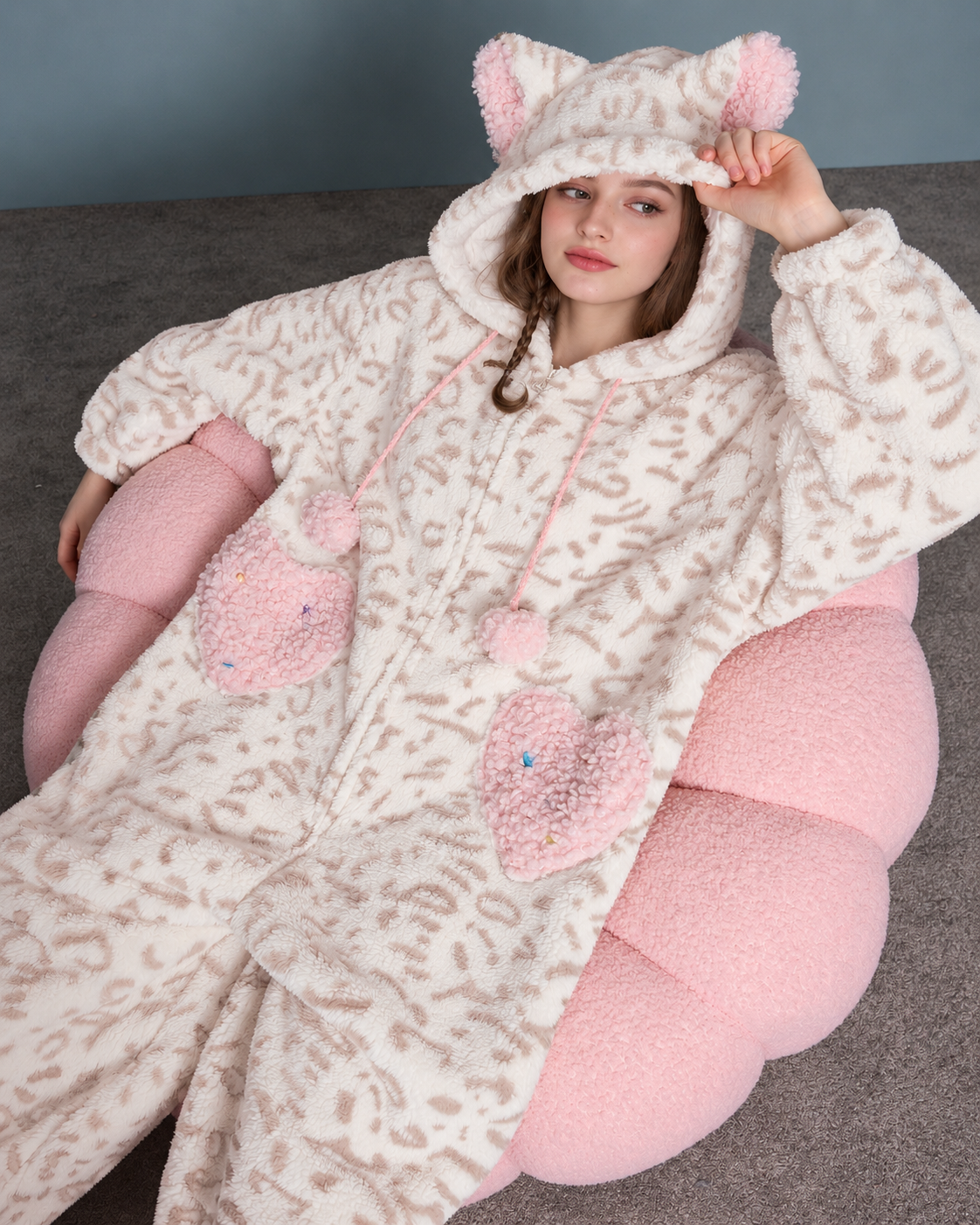 Cat-Ear Leopard Fleece One-Piece Pajamas – cream and pink relaxed seated view on a pink chair - Roomden