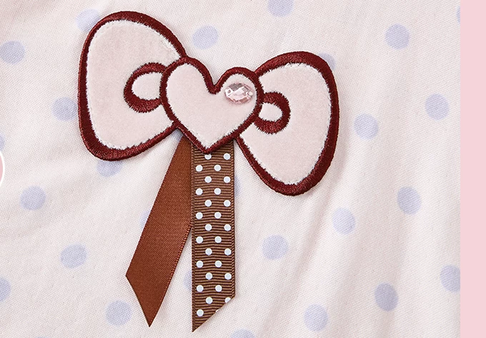 Close-up of heart-centered bow appliqué and ribbon detail - Roomden