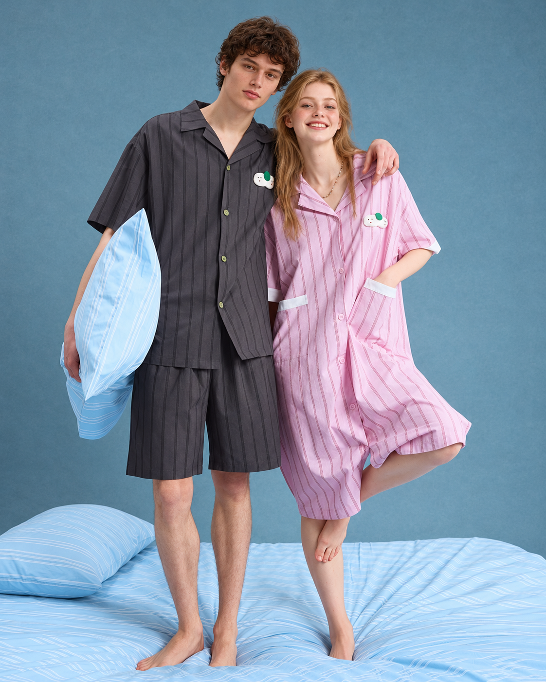 Men's Pinstripe Cotton Pajama Set – front view of the charcoal striped shirt and shorts on a blue bed - Roomden
