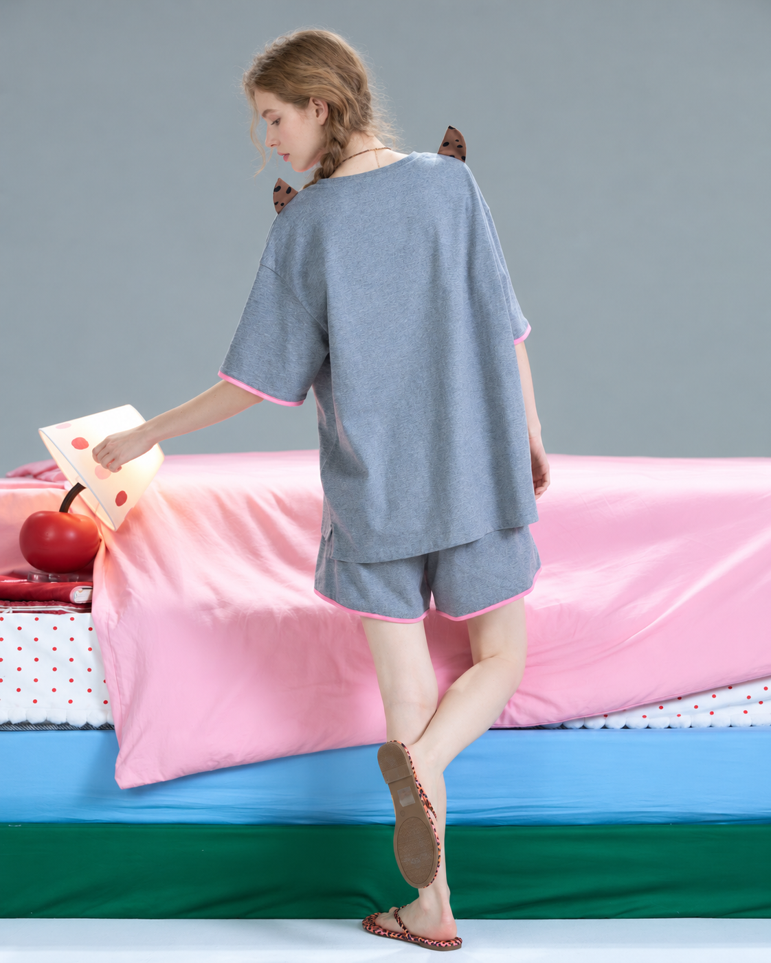 Cat Detail Short Pajama Set – gray back view beside a pink bed - Roomden