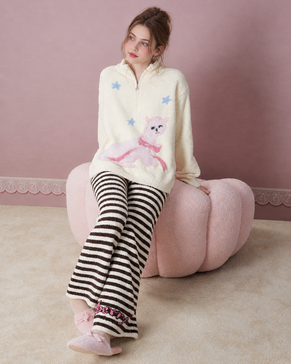 Cat and star pajama set in a full seated view on a pink chair - Roomden