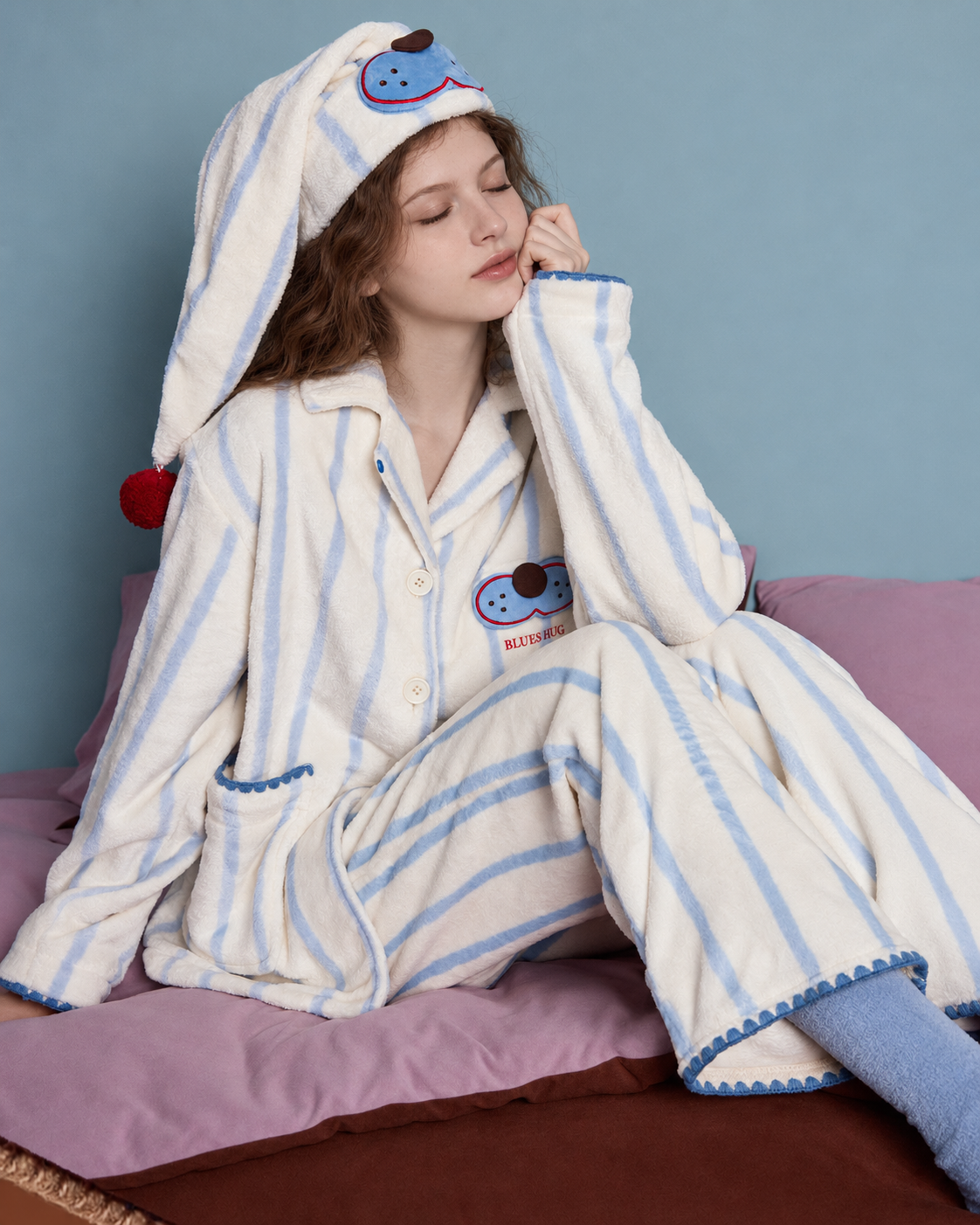 Striped Fleece Pajama Set – relaxed seated view on a mauve sofa - Roomden