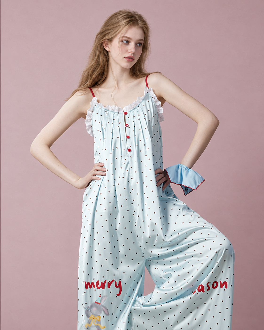 Red-button pale blue pajama jumpsuit shown with hands on hips and raised knee - Roomden