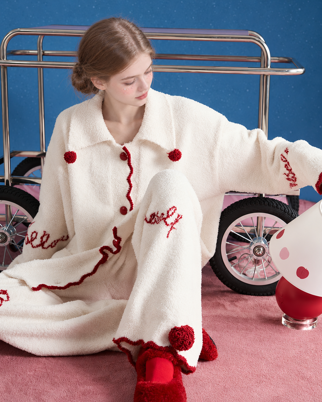 Pom-Pom Fleece Pajama Set – ivory side floor-seated view with collar pom-poms - Roomden