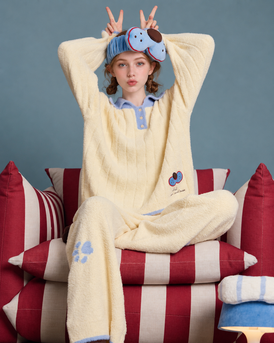Plush Paw Print Pajama Set – cream yellow and blue seated playful hand pose - Roomden