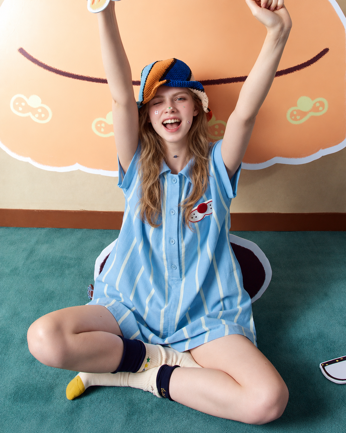 Cotton Gauze One-Piece Pajamas – blue striped romper in raised-arm seated pose - Roomden