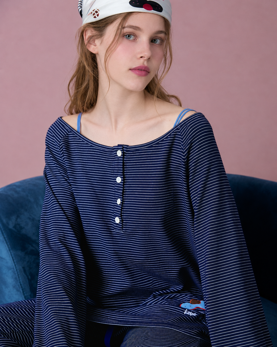 Striped Cat Embroidery Pajama Set – navy neckline close-up seated in a blue chair - Roomden