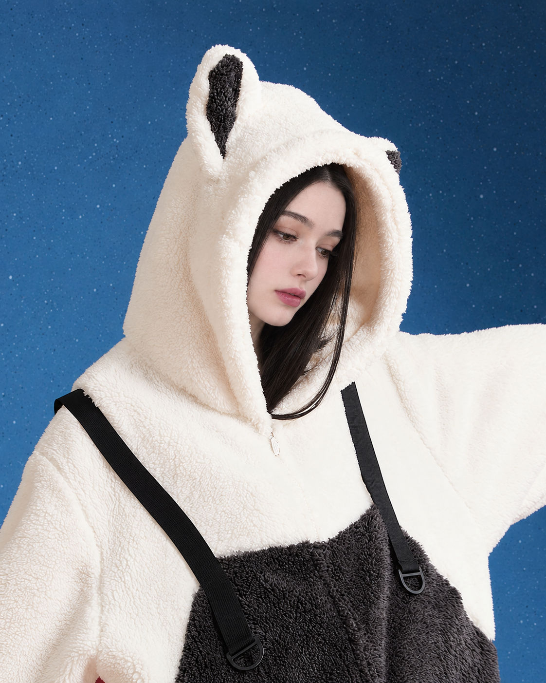 Shoulder and hood close view of black-and-white cat-ear fleece one-piece pajamas