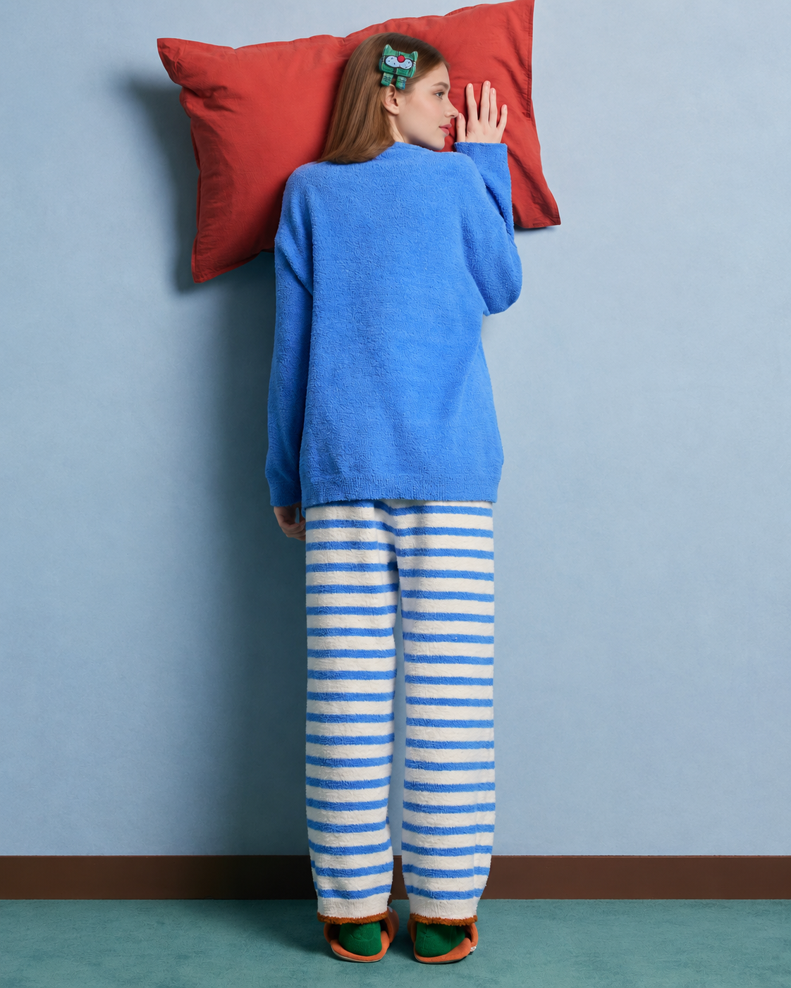 Blue cat graphic fleece pajama set with cream striped pants – Back view with pillow