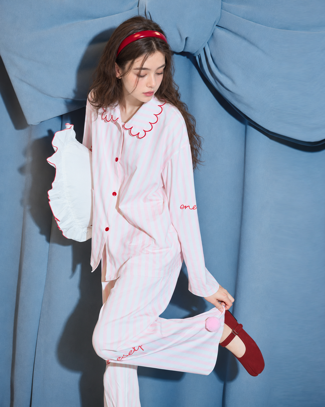 Scalloped Stripe Cotton Pajama Set – raised-leg pose showing a pink pom-pom hem - Roomden