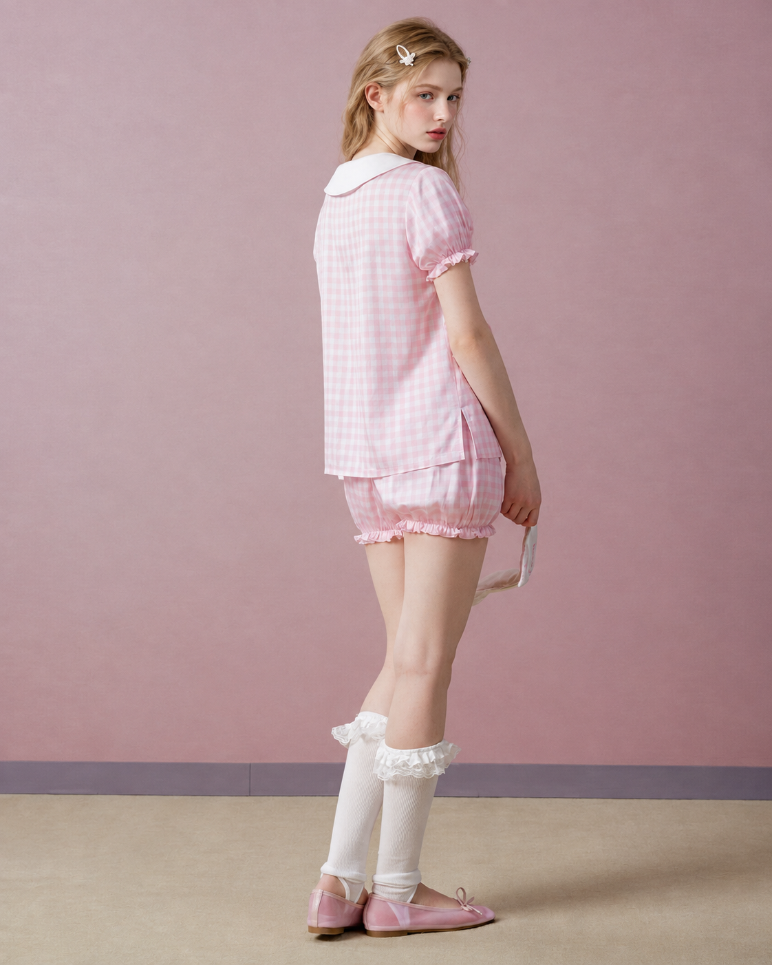 Back view of pink gingham short pajama set with a white collar.