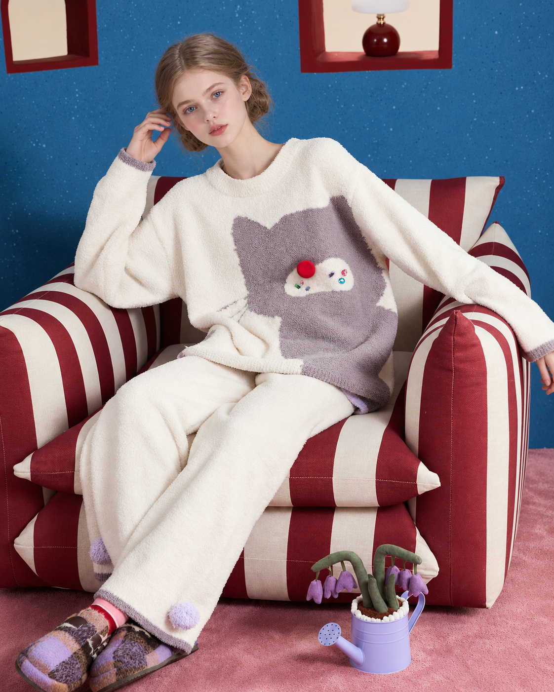 Ivory cat graphic pajama set – relaxed seated view in a striped armchair - Roomden