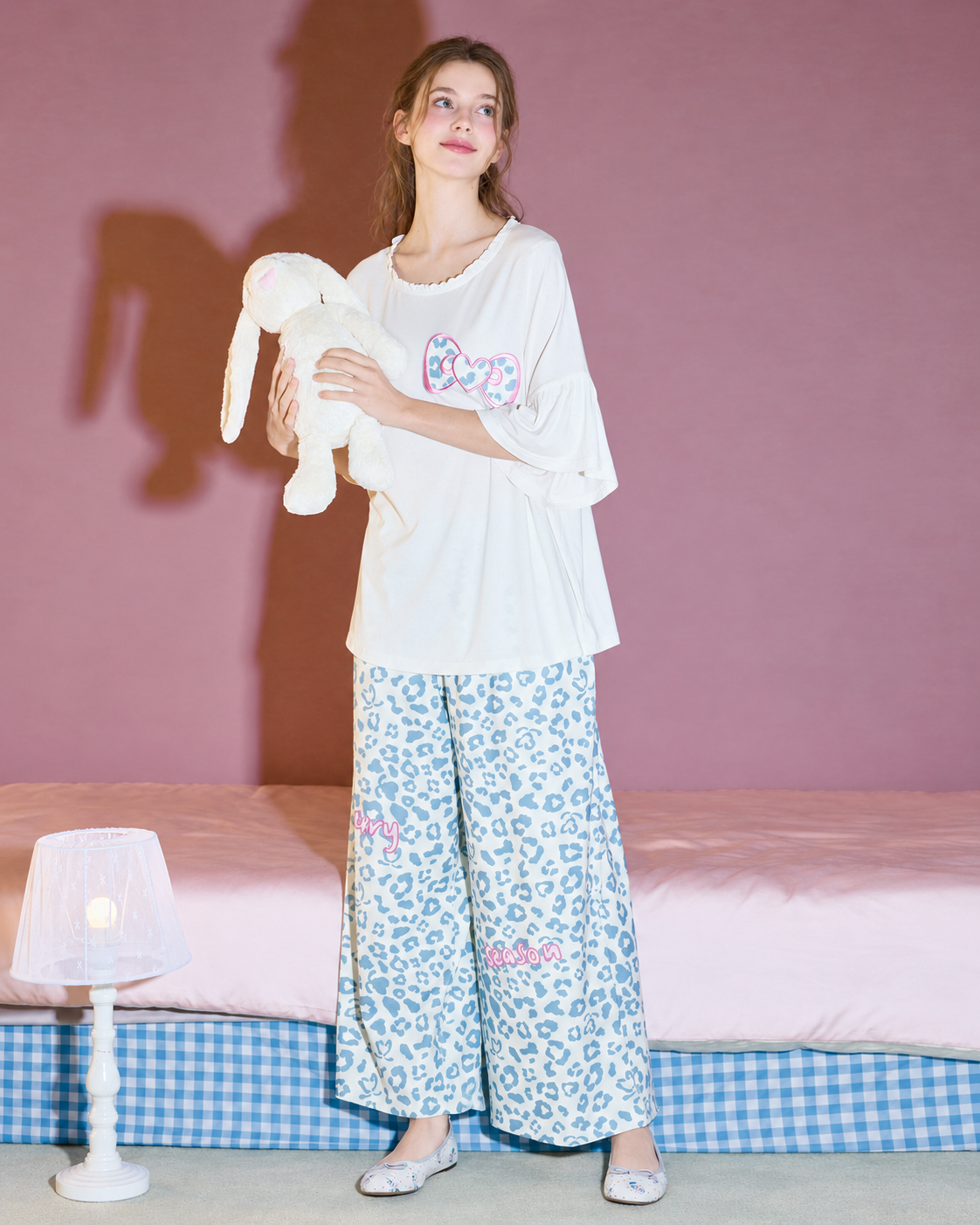 Heart Bow Cotton Blend Pajama Set – standing view with an upward gaze holding a rabbit - Roomden