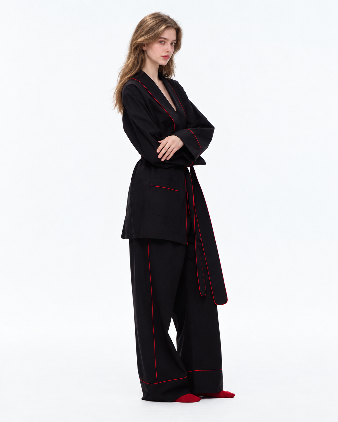 Linehaven wrap pajama set – Classic Black, side view with crossed arms in the studio - Roomden