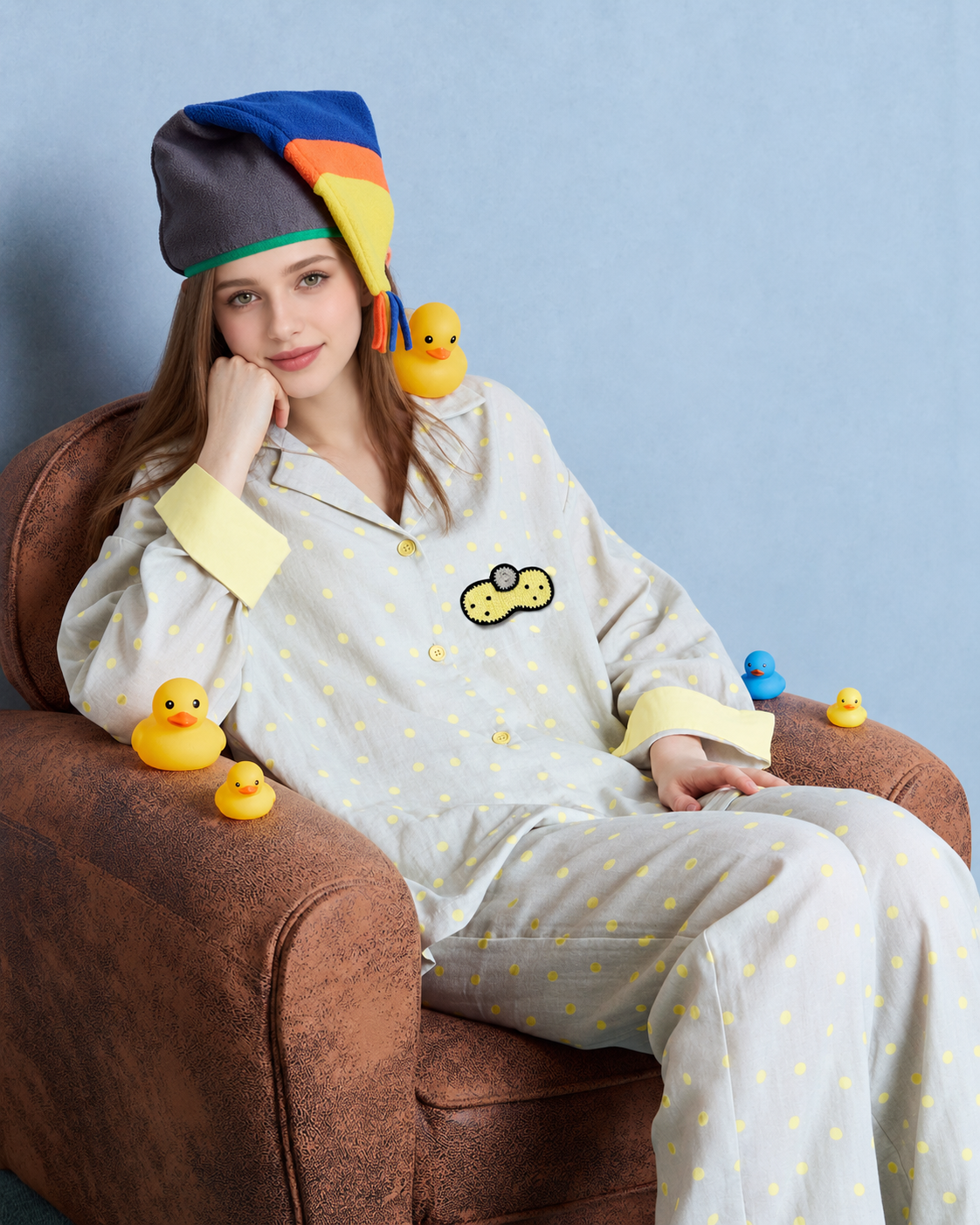 Women's gray and yellow dot cotton gauze pajama set – seated view leaning on an armchair - Roomden