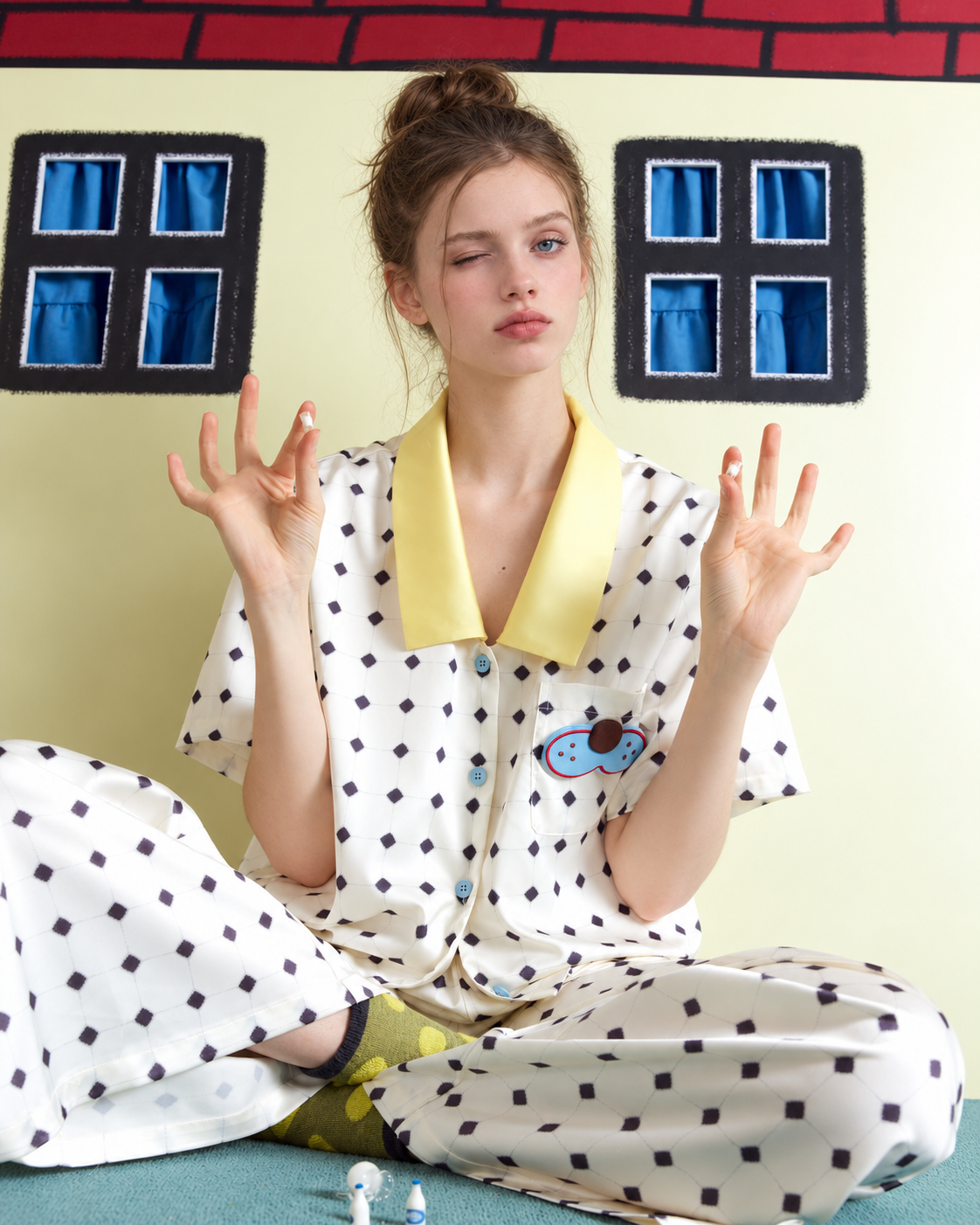 Lemonpause Short-Sleeve Pajama Set – ivory cross-legged pose against a yellow wall - Roomden