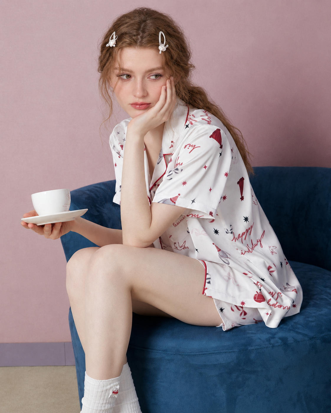 Gift Print Satin Short Pajama Set – white and red print, seated side view with cup - Roomden