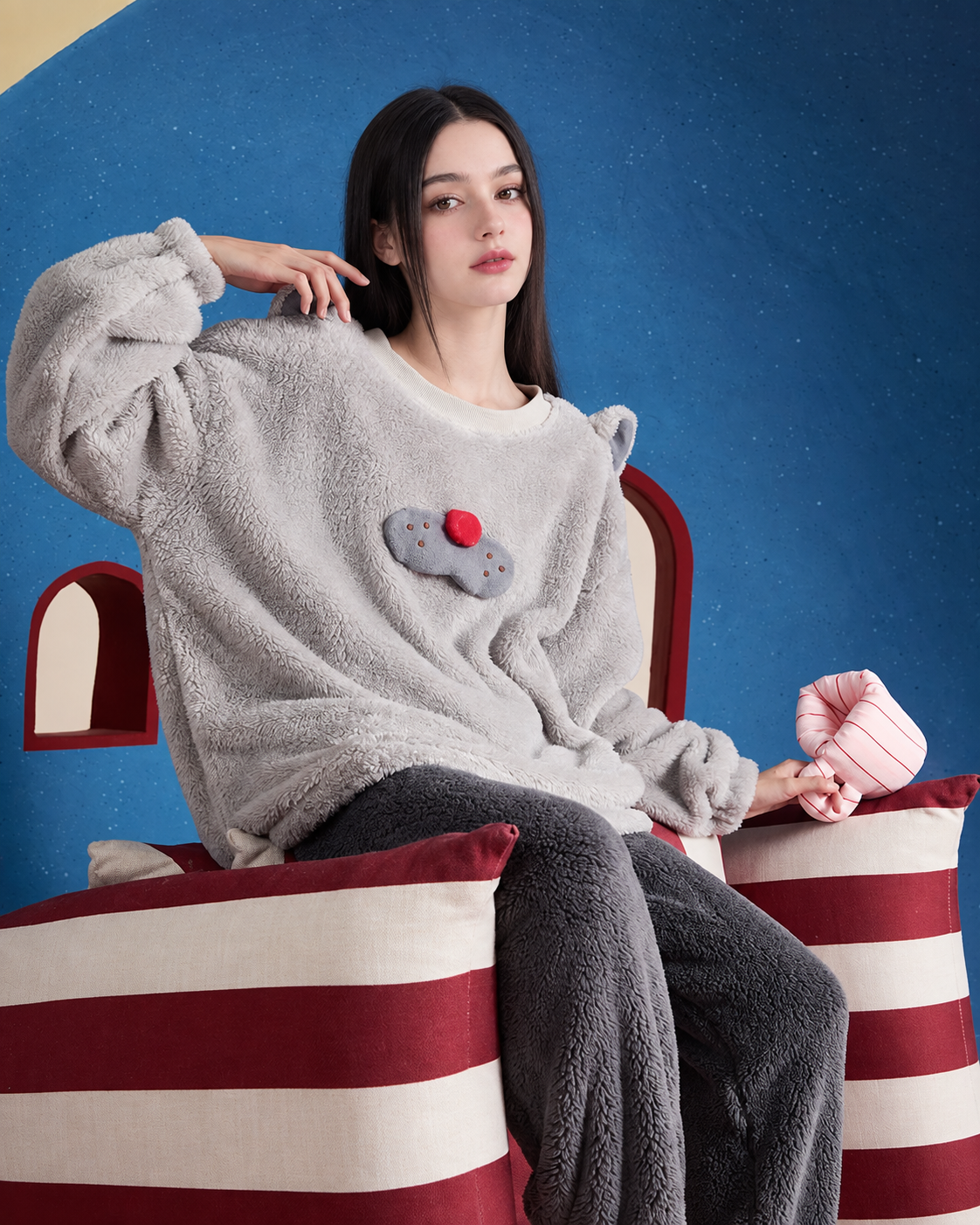 Cat-Ear Fleece Pajama Set – gray set seated sideways on a striped sofa - Roomden