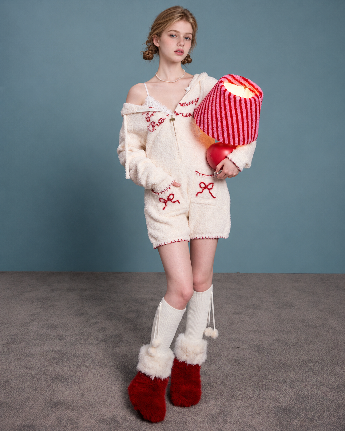 Rabbit-Ear Fleece Onesie – cream standing view holding a striped lamp - Roomden