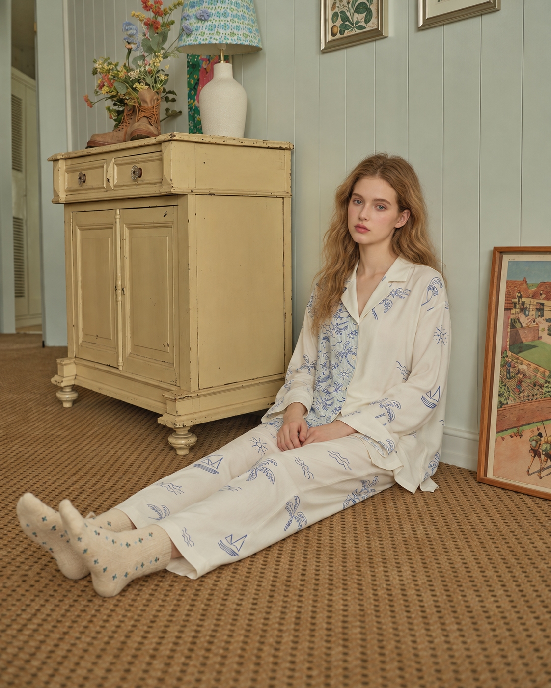 Inkshore asymmetric coastal-print viscose pajama set in Apricot Cream, seated on a vintage-room carpet - Roomden