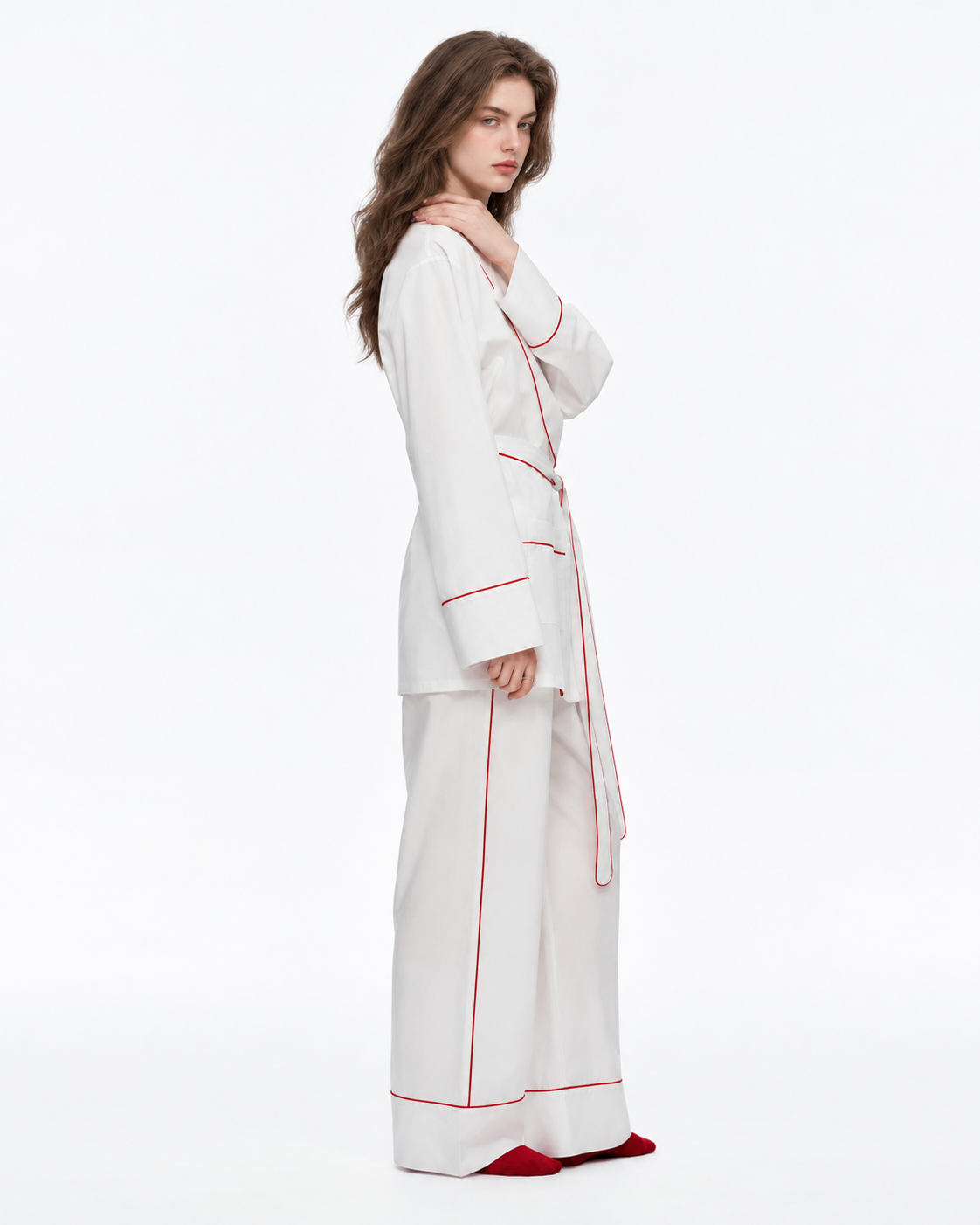 Linehaven wrap pajama set – Milky White, side pose with a hand at the shoulder in the studio - Roomden