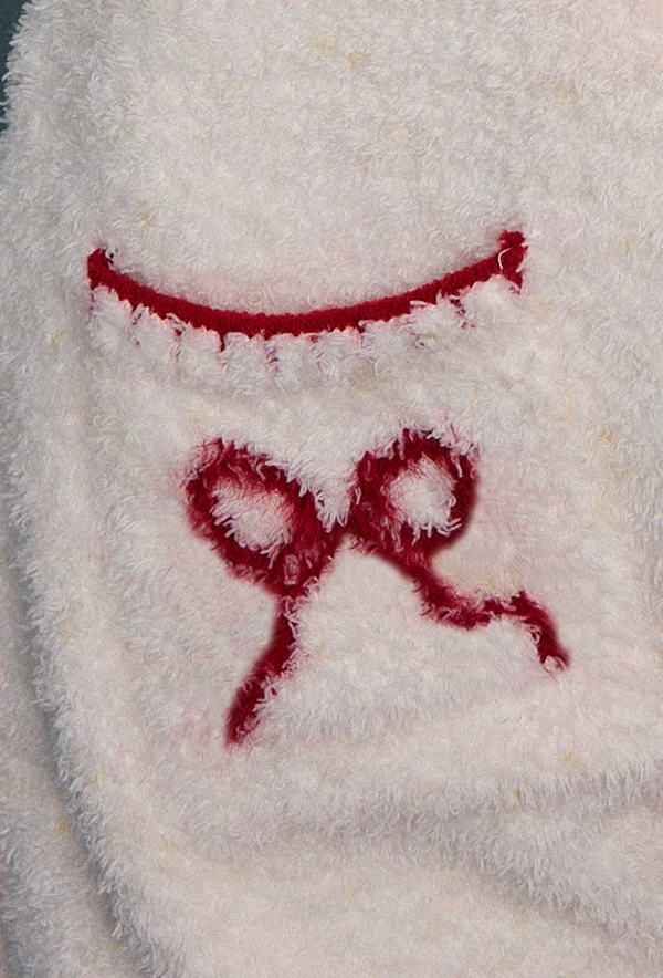 Rabbit-Ear Fleece Onesie – cream bow pocket and plush fabric detail - Roomden