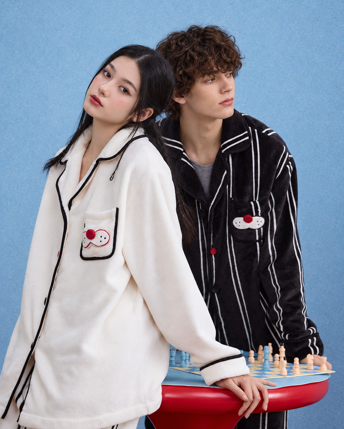 Men's Striped Cat-Pocket Fleece Pajama Set – Black, standing back-to-back beside a chess table - Roomden