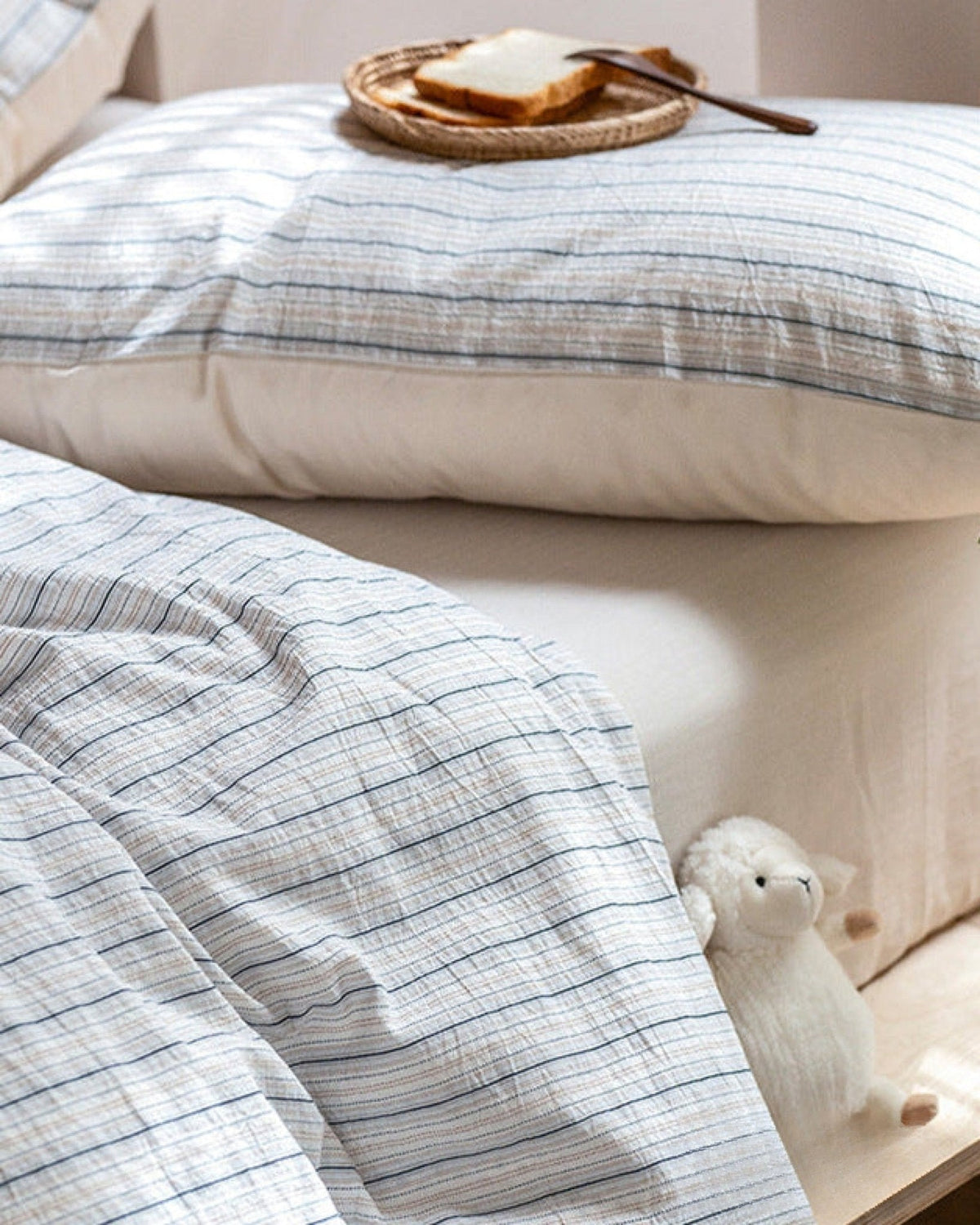 Winslet Pinstripe Cotton Bedding Set – striped pillows and duvet folds with a tray on the bed - Roomden