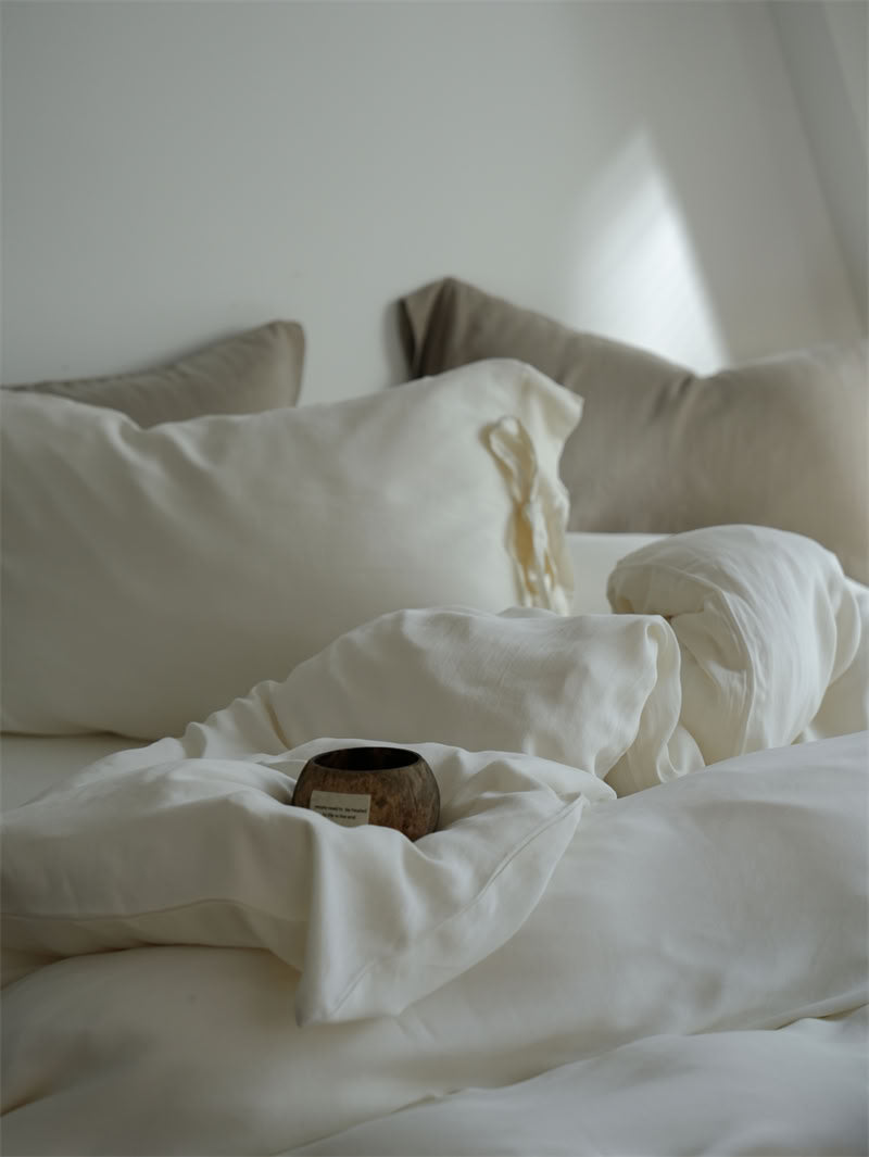 Close-up of smooth Tencel fabric with ribbon-tie pillow detail – RoomDen