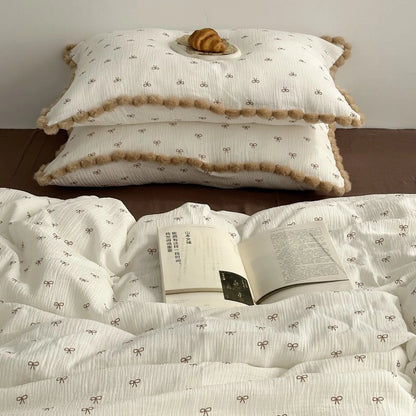 Stack of soft pillows showing the crinkled texture and brown bow motif