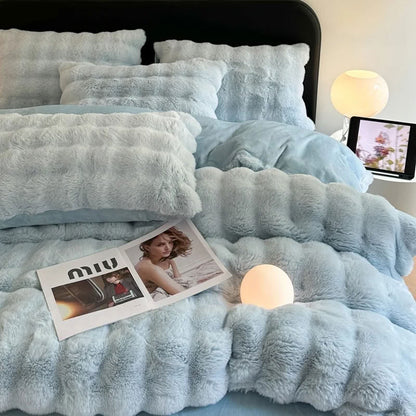 Soft light blue faux fur bedding styled with magazine and cozy lighting – RoomDen