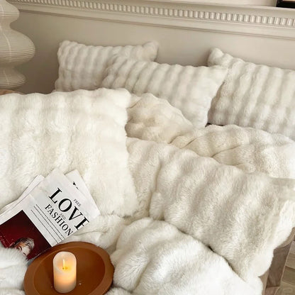 Cozy white plush bedding set with magazine and candle decor – RoomDen