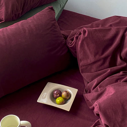 Solid Wine Red velvet bedding set with soft plush texture and minimalist cozy bedroom scene - RoomDen