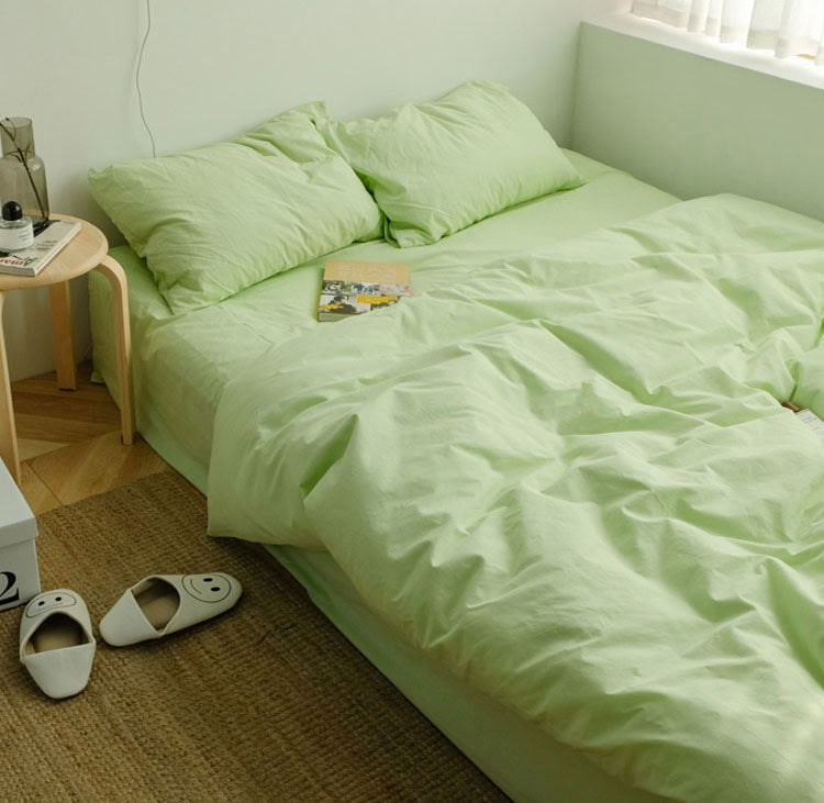 Apple green washed cotton bedding set with pillows and a cozy relaxed setup - RoomDen 
