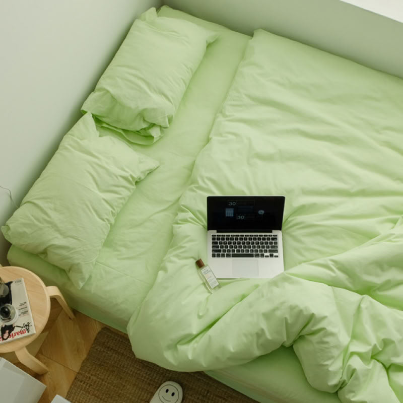 Apple green washed cotton bedding set with pillows and a cozy relaxed setup - RoomDen 