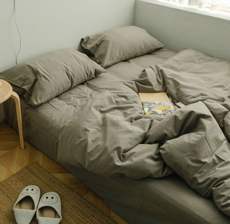 Olive green washed cotton bedding set with pillows and a cozy natural bedroom look - RoomDen