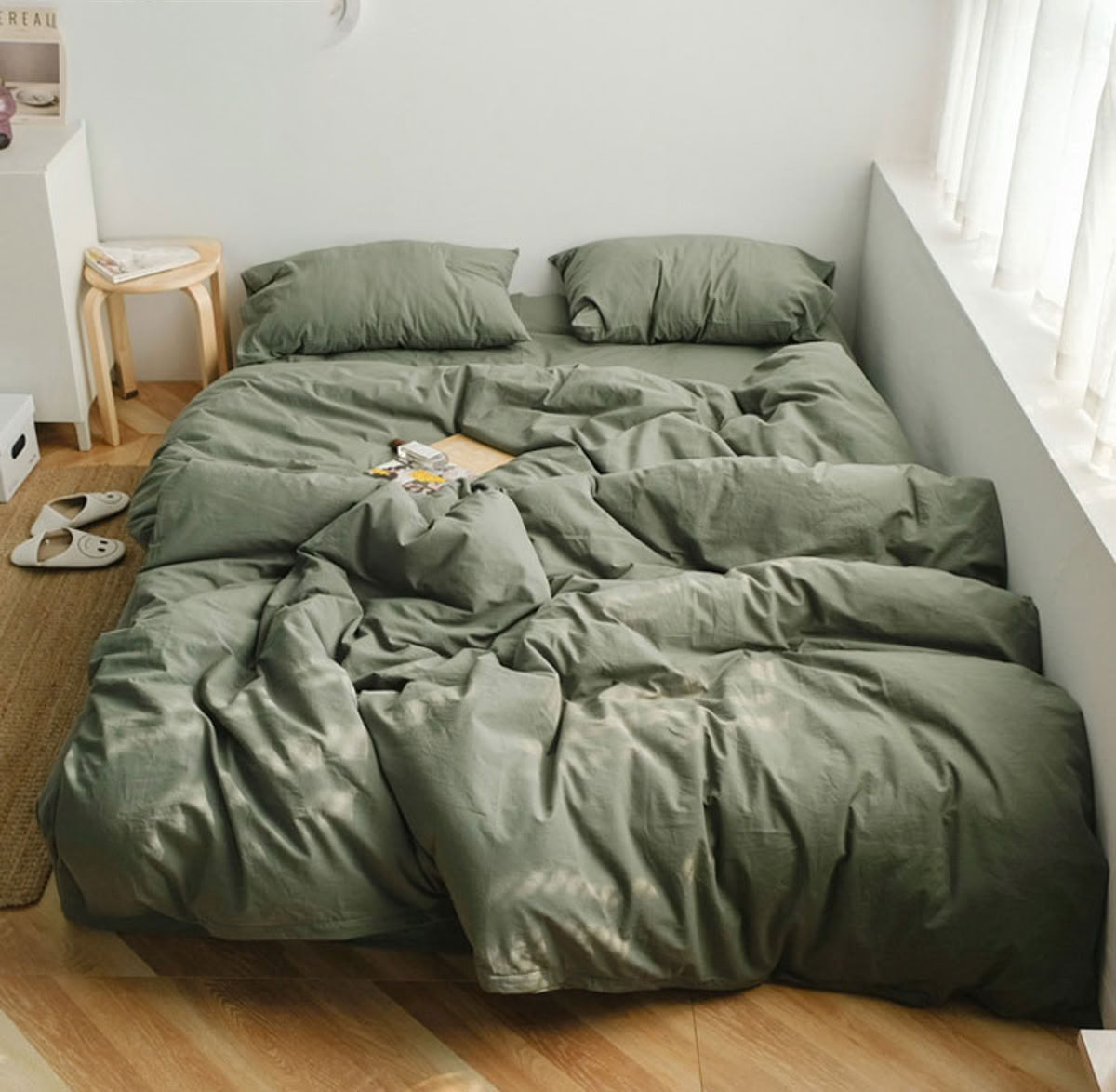 Calm sage green washed cotton bedding set creating a soothing earthy bedroom look - RoomDen
